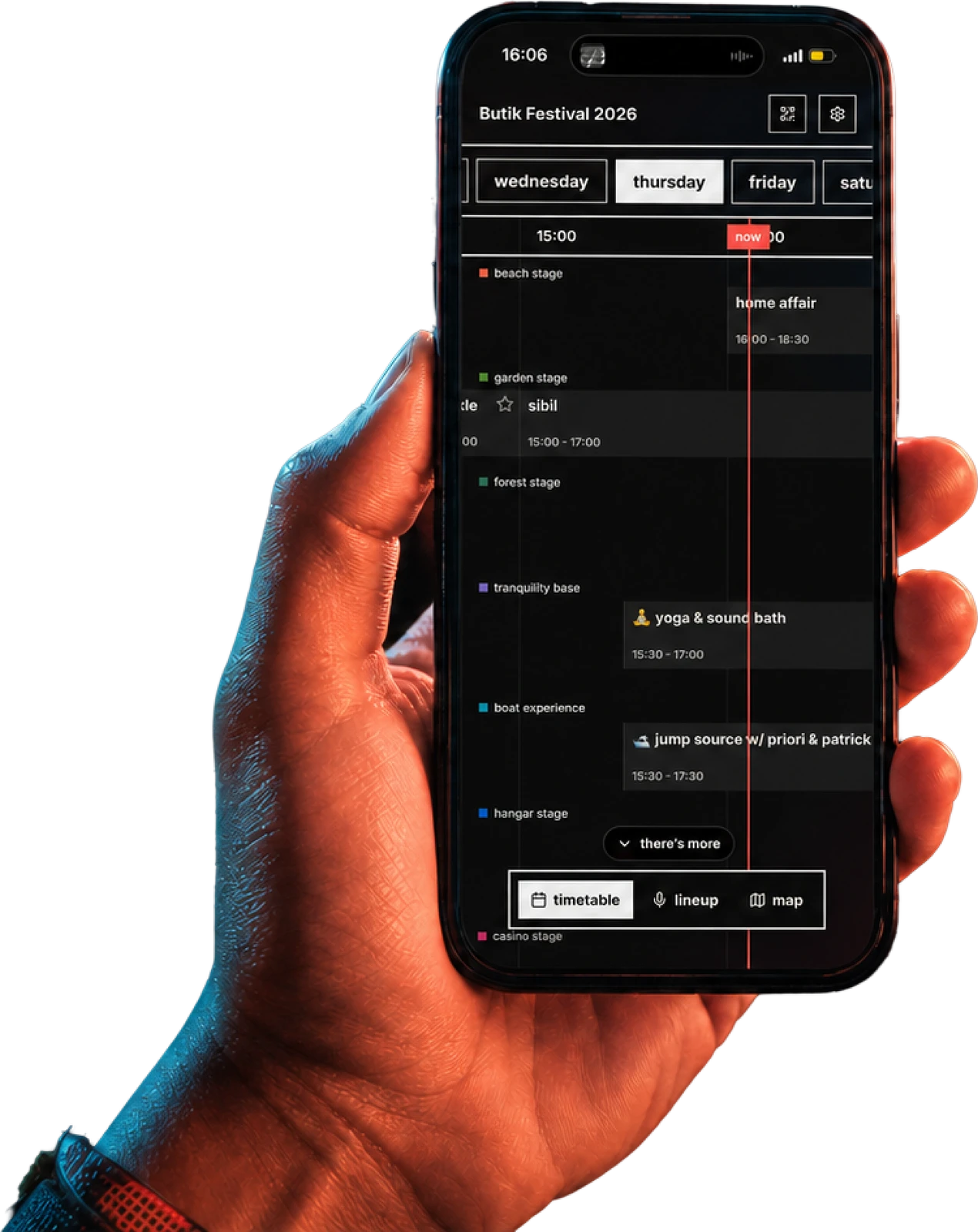 A hand holding the Butik festival timetable app.